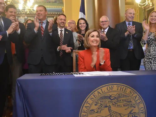 Governor Reynolds signing property tax bill