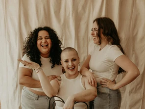 Three women gathered around