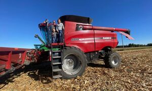 Governor Reynolds with farm family and combine harvester