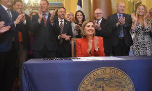 Governor Reynolds signing property tax bill