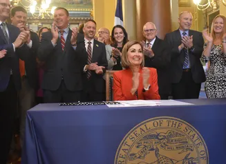 Governor Reynolds signing property tax bill